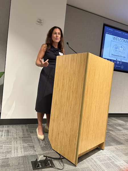 Arianne Adams speaking at the podium during the New York City Evening of Excellence