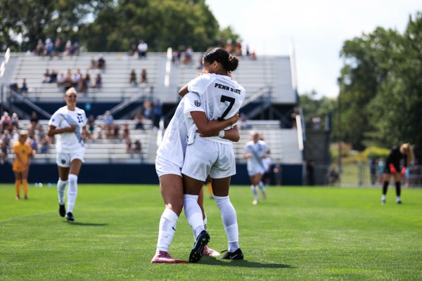 Amelia White celebrates with a teammate against West Virginia
