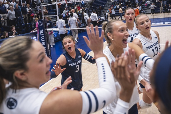 Women's Volleyball huddles after a point against Maryland